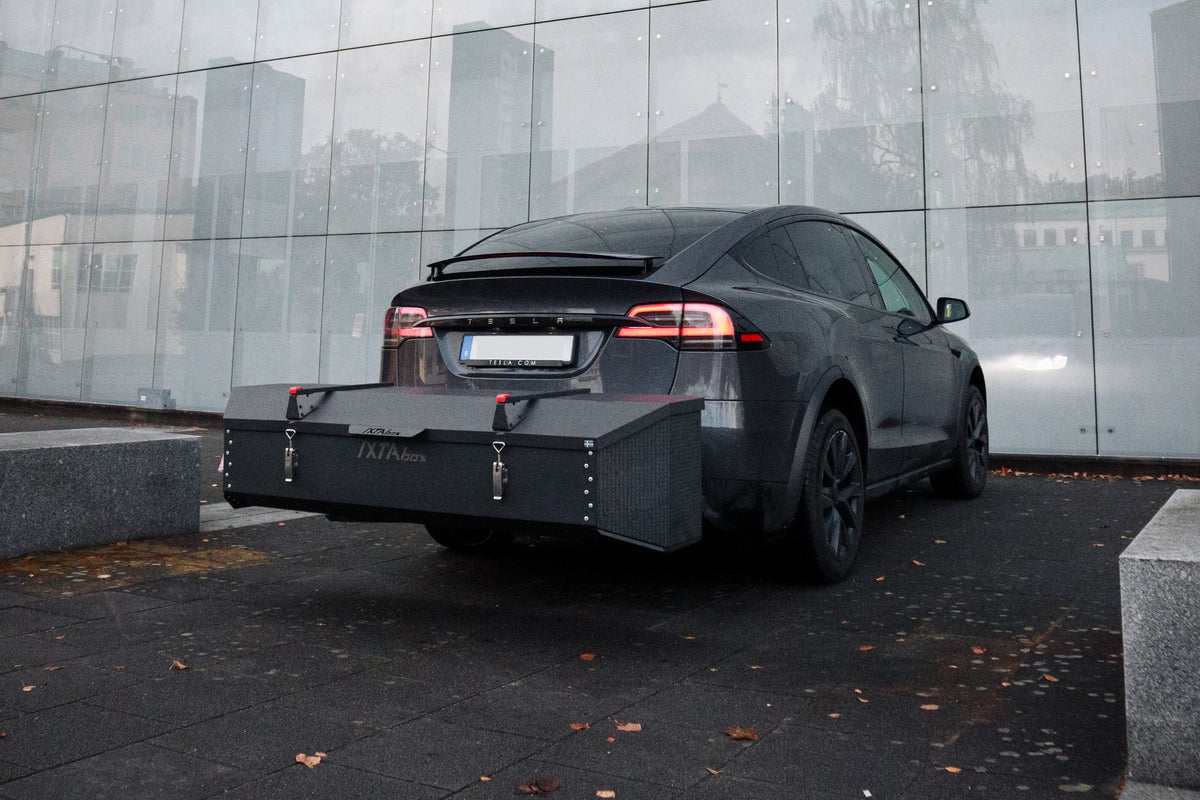 Tesla with an IXTAbox cargo box attached to the tow bar